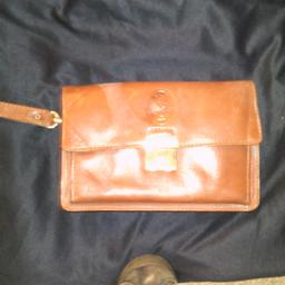 mans every day bag brown /combination lock /several different size pockets /leather with handle