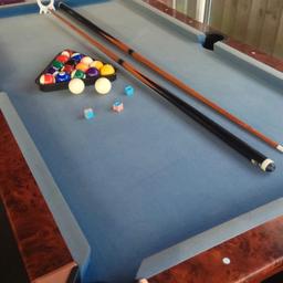 Pool table with pool balls, triangle and one cue. colour faded on the top. Playing area is roughly 31 X 64 inches and outer measurement is 40 X 72 inches.
