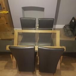 Large glass dining table with oak legs and 6 black leather high backed chairs.
Selling due to house move.

Table measures 180cm x 90cm (71" x 35")

Collection Only! Glass comes away from base for easy transport.