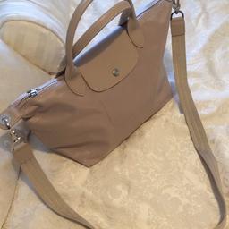 Cream medium sized pilage longchamp bag. It has a satchel so can be worn as a side bag. This is a limited addition piece and is no longer on the market. It is in very good condition and has only been worn once. It is made of premium thick material rather than the usual longchamp pvc material. Can be posted