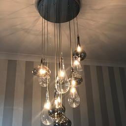 Chrome and clear/smoked glass 12 pendant light. Full working order, one bulb needs replacing. 

Collection only.