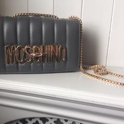 Moschino replica bag. Grey pu leather with gold detail.
Brand new never used. From a smoke and pet free home. Collection only