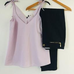 Women’s bundle size 8

RIVER ISLAND pink/lilac vest with tie up details to straps. Size 8
PER UNA (M&S) semi tailored navy blue trousers with gold zips size 8

Excellent condition