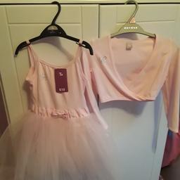Pink ballet dress with attached tutu, aged 7 (small fit), tags still attached as never been worn. Pink wrapover top, aged 5, also never been worn. Pink ballet shoes, size 11 (small fit) never been worn.