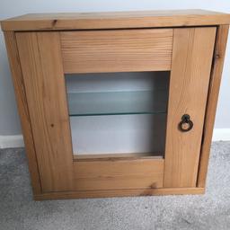 Small wooden display cupboard with glass panel to the front and glass shelf inside.