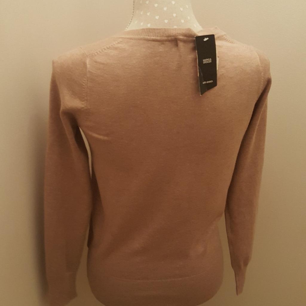Brand new with tags. M&S v neck jumper. Nice detail throughout. Soft touch. Beige/Caramel colour. This jumper is not acrylic. Size 10.