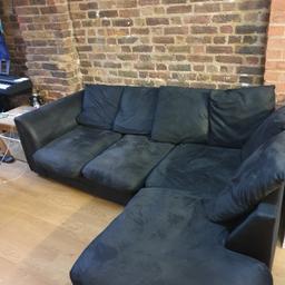 Black, soft suede corner sofa. In decent condition. Can separate into two pieces for easier moving. Very comfy and no issues except the small connector needs rescrewing. Pick up only.