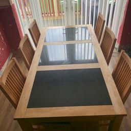 Solid wooden dining table with 3 marble pieces and 6 leather based chairs, in fantastic condition, very heavy will need 2 people to collect