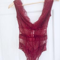Pretty little thing burgundy lace body new with tags on 
Size 8