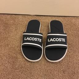 These are a pair of navy blue and white Lacoste sliders that are a size uk 5.
In good condition as only wore once on holiday.