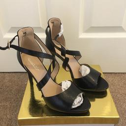 These are a pair of brand new with the box black cross over strap peep toe heels. 
Size uk 6 / 39