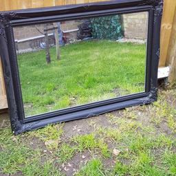 very heavy black mirror. solid rings on all 4 sides for hanging. some minor Damage which has been touched up ( although not in picture ) and is no longer visible
