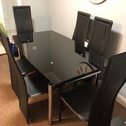 Black glass dining room table and chairs