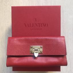 Rockstud Red leather clutch purse

Comes with the Valentino box

Like new (only tiny tear at one corner due to the wrist strap missing as seen on last photo which can be easily glued or stitched) The price takes this into account.