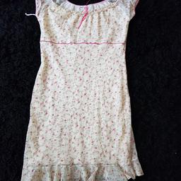 New look - never worn pretty yellow floral dress, size 14 yellow under slip covered with yellow floral material, with cerise threading on the arms topped off with a pretty cerise ribbon, 100% nylon.