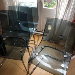 Four grey Perspex and metal dining chairs. Some scratches to the plastic. Collection only N8.