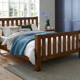 solid Oak wooden 
High headboard
The is a very heavy chunky wooden frame with sturdy side rails. Solid slat only 2 years old very good condition comes with Dreams comfy pocket sprung double 2 years old mattress collection only.