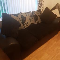 2 black leather and black material sofas. very good condition. small tear to one of sofas but can't see it, as it's on the back of the sofa. silver and black flowered embroidered cushions and black cushion seats. quick sale as getting a new one delivered. pick up only.