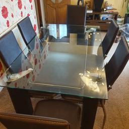 Brown dining table with 6 chairs,very nice looking ( some scratches on it and a chair will need  4 screws)
