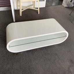Gloss white coffee table / TV stand in good condition. Some small marks from use.
