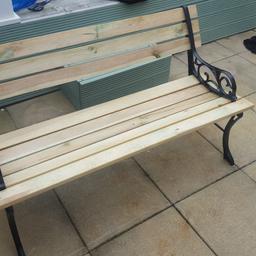 Garden bench with cast iron ends and treated wooden boards. 4ft long