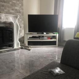 White gloss tv stand with black glass top and doors 

Bought from John Lewis excellent condition selling as tv is going on the wall   

Collection only or delivery available for £10