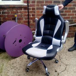 black and white gaming chair. The arms will go up or down. And the chair will tilt. in good condition. Son had it for a year or so.