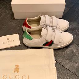 Stunning Gucci Authentic Kids White ace Velcro trainers Sneakers Shoes In Size Uk 13, Eu 32, have in the past gone over with leather shoe whitening to keep the white and clean looking, some signs of wear, and some fading to the green writing at the back, please see all pictures, but still in good condition comes with box and dust bag, still online fo £200, son grew out of them. accept PayPal.

Description
White leather with green and red web
Velcro fastening
Made in Italy