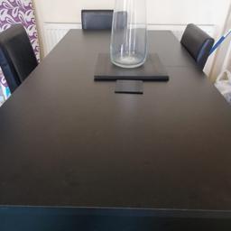 Black extending dining table with 6 leather chairs  one chair has a small mark on it