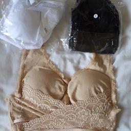 1 beige 1 black 1 white bras with cross over lace to lift and support. Have pads but can be worn with or without. Brand new still in pks