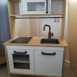 Play kitchen with cupboards, sink and hob with working lights. From smoke free, pet free home.