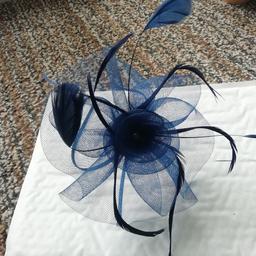 Navy blue, flowery, headband fascinator worn only once,and don't have any more weddings on the calendar so seems a shame to go to waste! Big and bold, comfy to wear. (Didn't pinch behind ears like some headbands.)