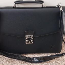 black leather, unused, push lock, with shoulder strap and key, zip compartments and internal pockets. W40xH28xD5 cm