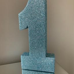 In light blue silver glitter. 
Practically brand new. 

Ideal for a first birthday celebration.