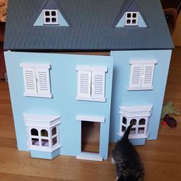 wooden dolls house with accessories door needs putting back on that's it. in very good condition