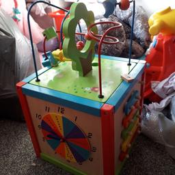 hardly been used 
lovely wooden toy that has different activities each side - clock, chalk board and games 

perfect condition