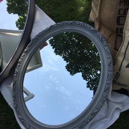 An Upcycled mirror which is painted in Paris grey and then waxed.It is a plaster frame with an ornate flower and scroll design.Buyer collects