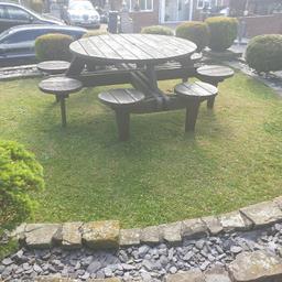 hi forsale us s large 8 seater solid wood round bench table, it's in good condition.
