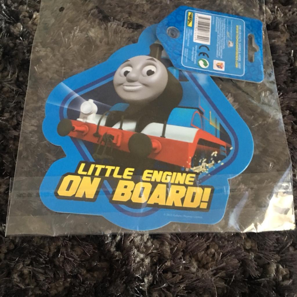 Thomas the tank engine double sided baby on board sign that is colourful and helps to make road users aware that children are on board the vehicle. Easy to attach with strong suction cups.