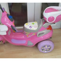 pink 6v electric ride on scooter in good condition, comes with charger and flower helmet. only selling because daughter has outgrown it.