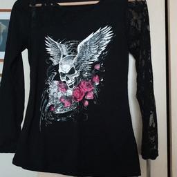 Black with long sleeves. One solid one lace. Winged skull with Roses on the front.