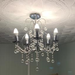 Beautiful Chandelier light with energy saver bulbs.Crystal droplets.In a perfect working condition.