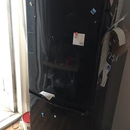 Black Daewoo Fridge Freezer. In working order. 
Bit battered on the sides. I had it given to me 12 months ago and works well. 
Small intermittent leak from the bottom which I have just tolerated. Would a shame to skip it but need it going ASAP. Collection only. No time wasters please.