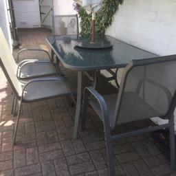 Grey framed  glass table and 4 chairs . Very good condition. Collection only.