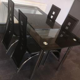 black glass table
4 leather chairs
black glitter tile center peice
used condition
