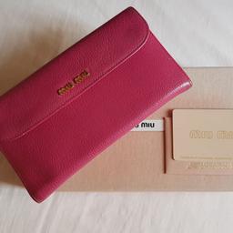 Used - in very good conditions. Original Miu Miu madras leather wallet, with one external pocket, zip coin holder, 13 card holder pockets and 4 cash pockets.  Bought it in 2014, available with original box and original authenticity certificate card.
