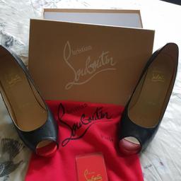 Size 5, black heels , 4" heel with 1/2" platform at front. famous red sole. comes with box and dust bag and new heel tips. slight dents in heels due to wear. see pics.