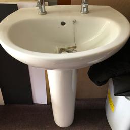 Bathroom pedestal sink complete with taps