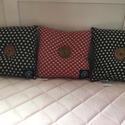 Set of three Kirstie Allsopp small square cushions. Two brown spotted, one red with hearts. All three have large button in centre. Excellent condition.