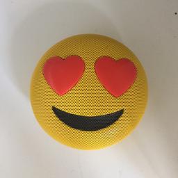 Round emoji speaker including a balance stand. New. Charger not included.